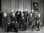Neville Chamberlian's war cabinet; Churchill is standing behind Chamberlain