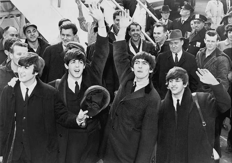 John Lennon (left) and the rest of the Beatles arriving in New York City in 1964